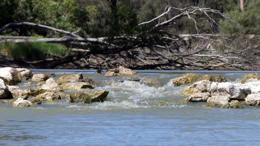 Flowing river over rock weir