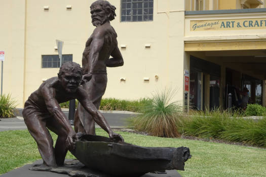 Sculpture of two aboriginal men pulling a canoe