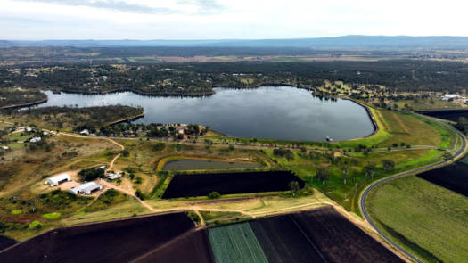 Looking down at lake surrounded by farmland