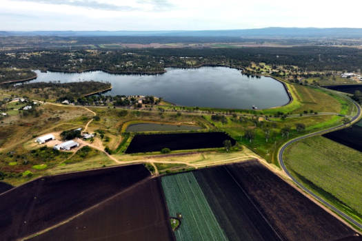 Looking down at lake surrounded by farmland