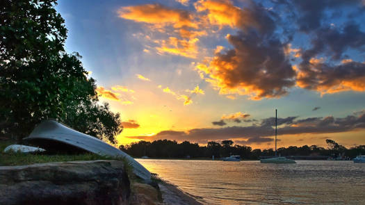 Sunset over river with boats